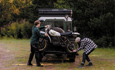 Elton Kings and Brook James attaching a motorcycle to the back of a Land Rover