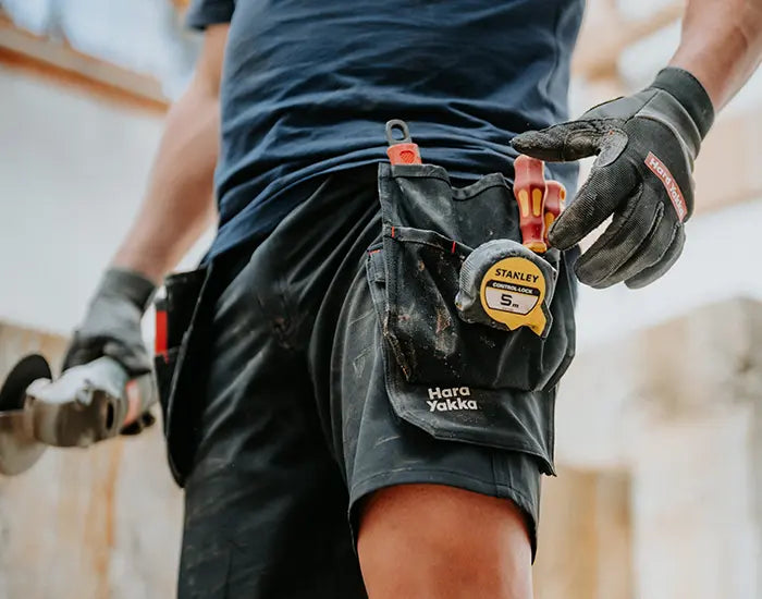 Man wearing a pair of Hard Yakka Holster Shorts with tools attached.