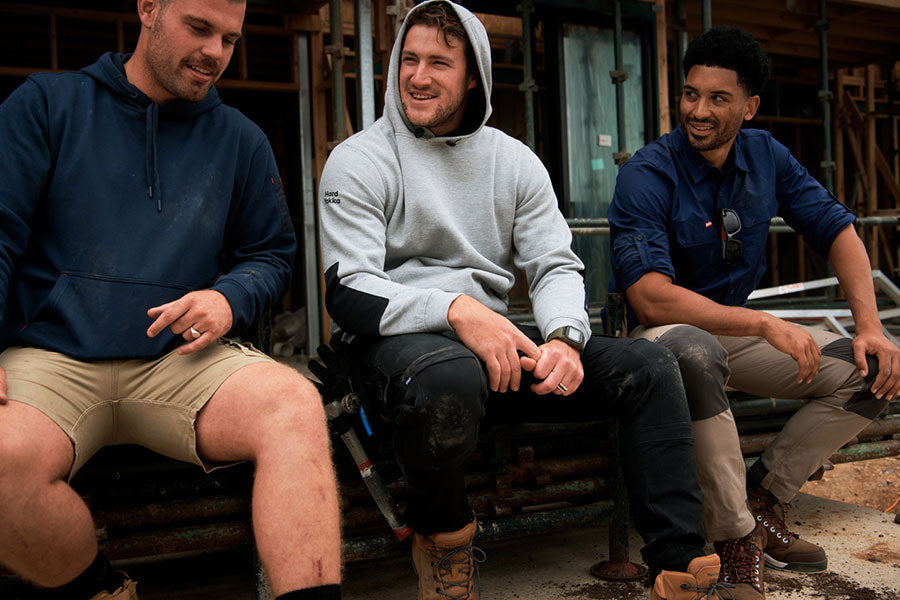 Three men talking and laughing, wearing Hard Yakka garments 